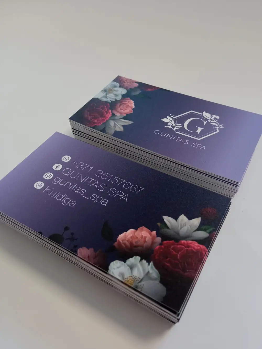 Purple business cards with a floral motif reading Gunitas SPA