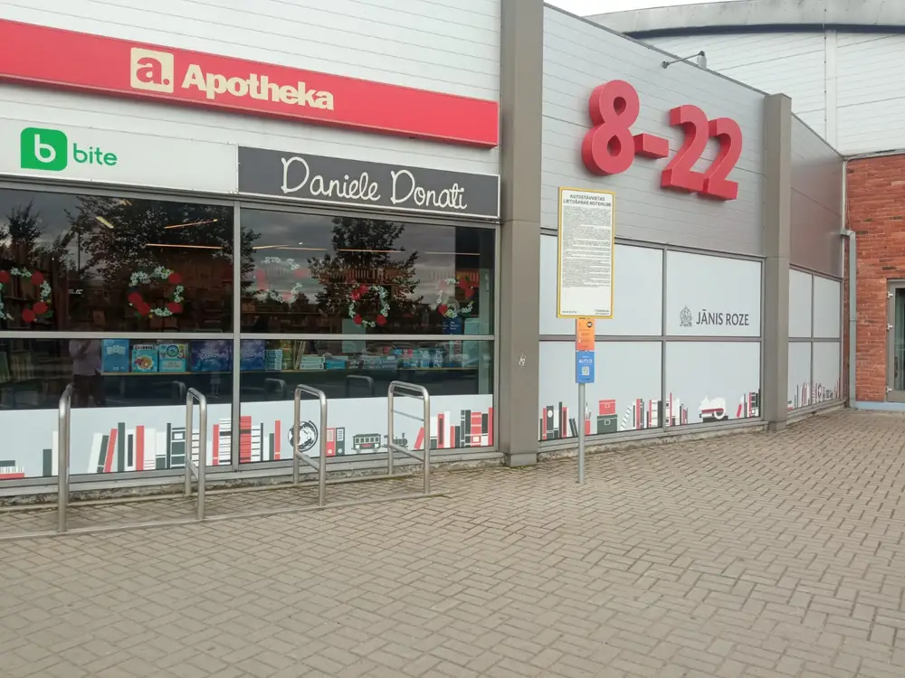 Shop front with bookshelf graphics on the windows and red numbers 8-22