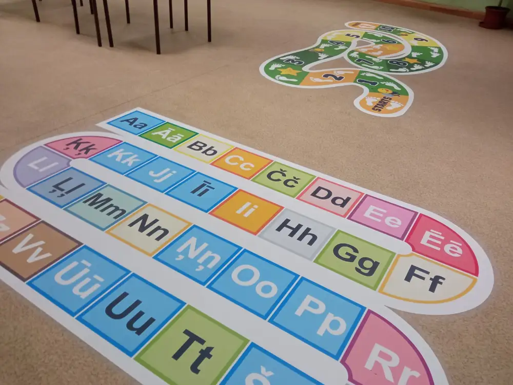 A colourful alphabet game and a snake-shaped play area stuck to the floor