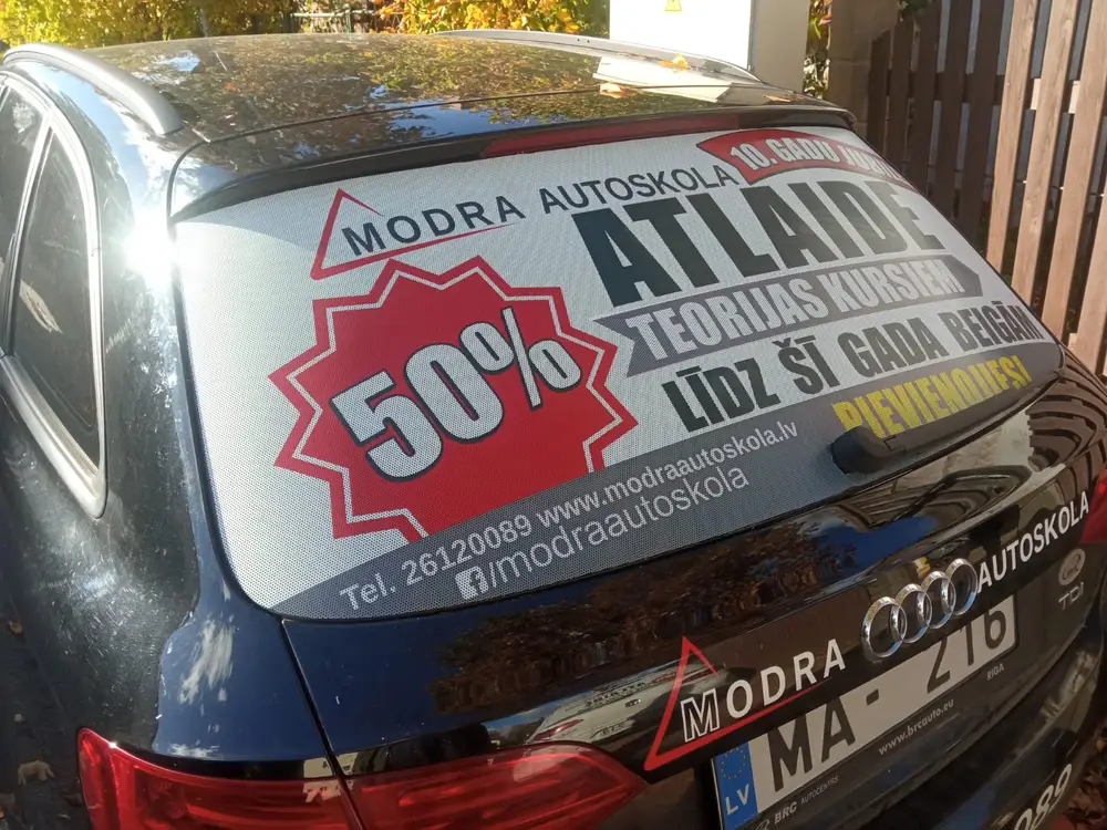 Audi rear window with a Modra autoskola ad offering 50% off theory courses