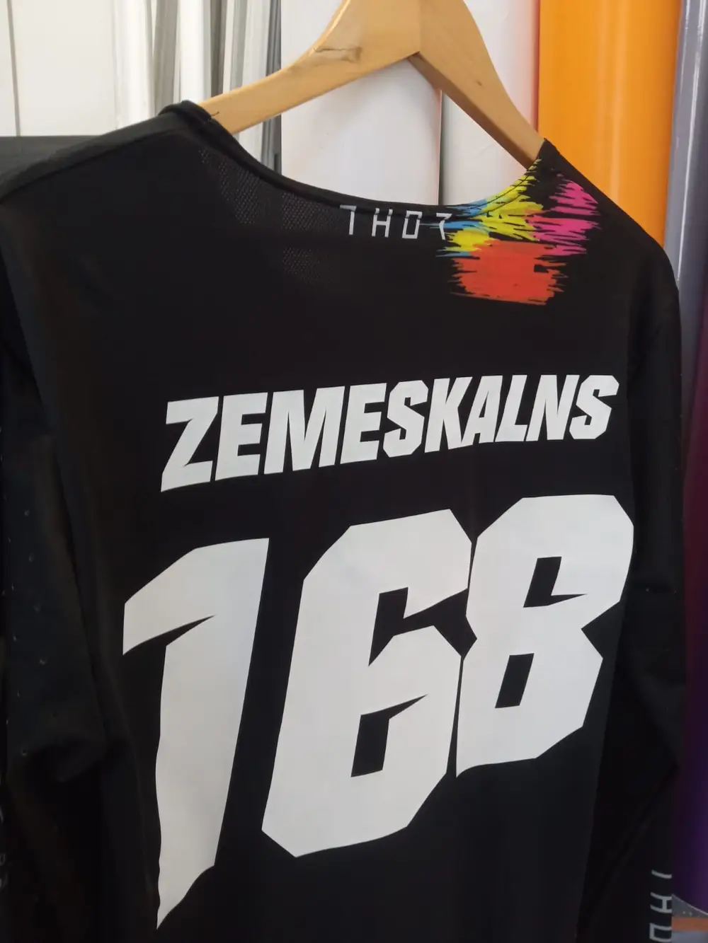 Black motocross jersey with a white surname and the number 168 on the back