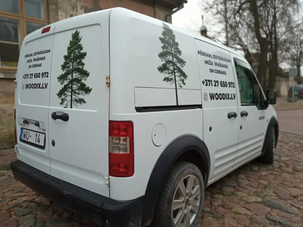 White van with pine tree images, the text woodix.lv and a phone number