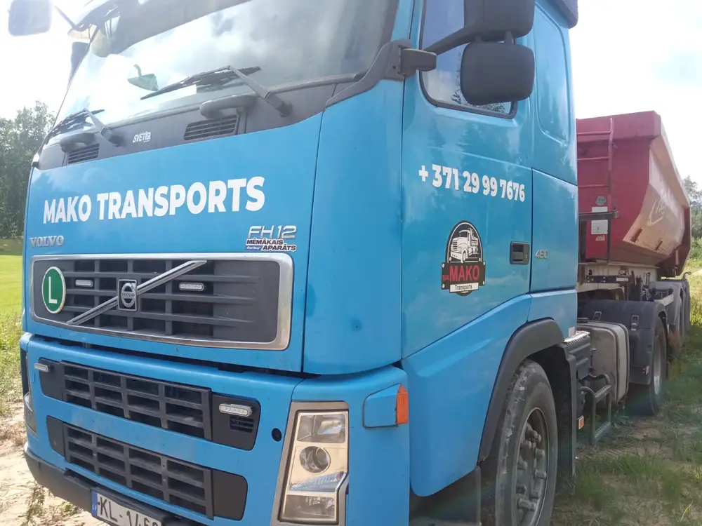 Blue Volvo tractor unit with white Mako Transports lettering and a phone number on the cab