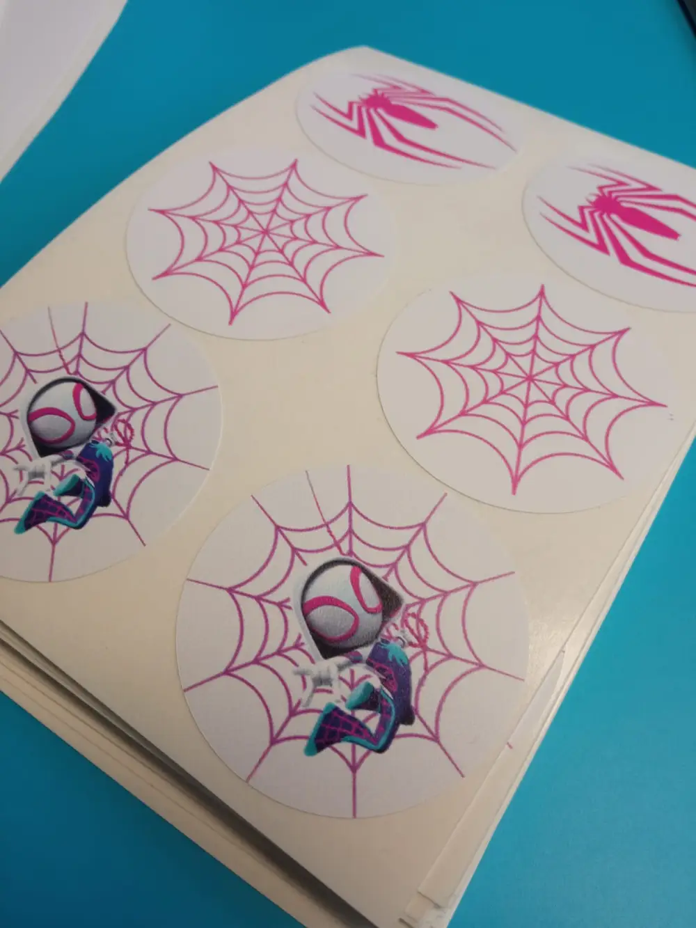 Sheet of round stickers with a pink spider web and a cartoon character