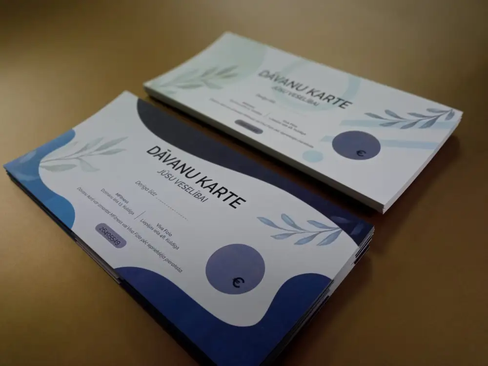 Gift cards reading "Jūsu veselībai" with a blue design and a leaf motif