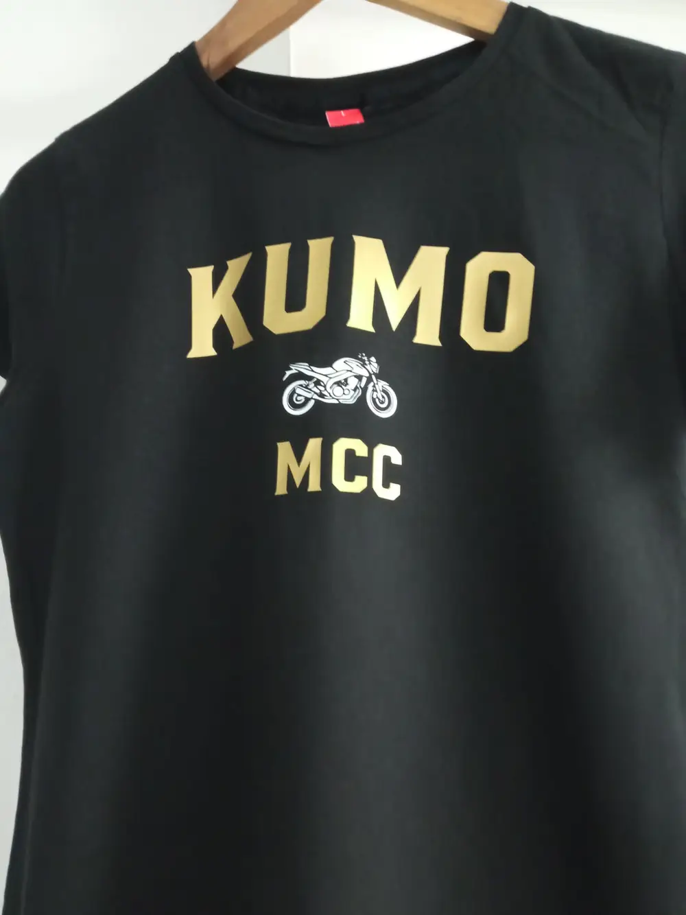 Black T-shirt with gold Kumo lettering, a motorcycle image and MCC
