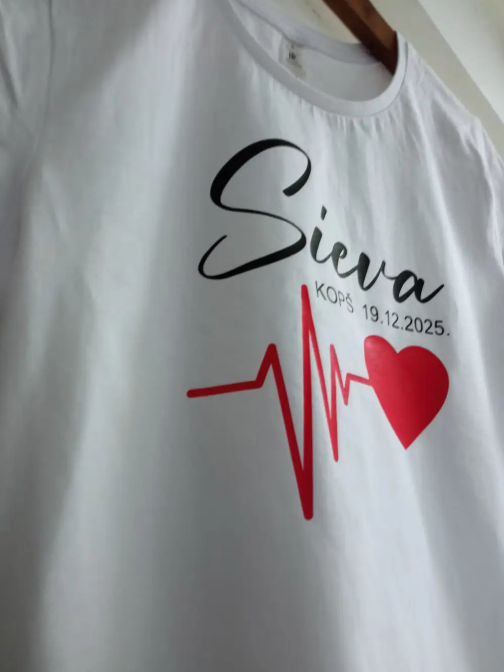 White T-shirt reading "Sieva kopš 19.12.2025" with a red heart