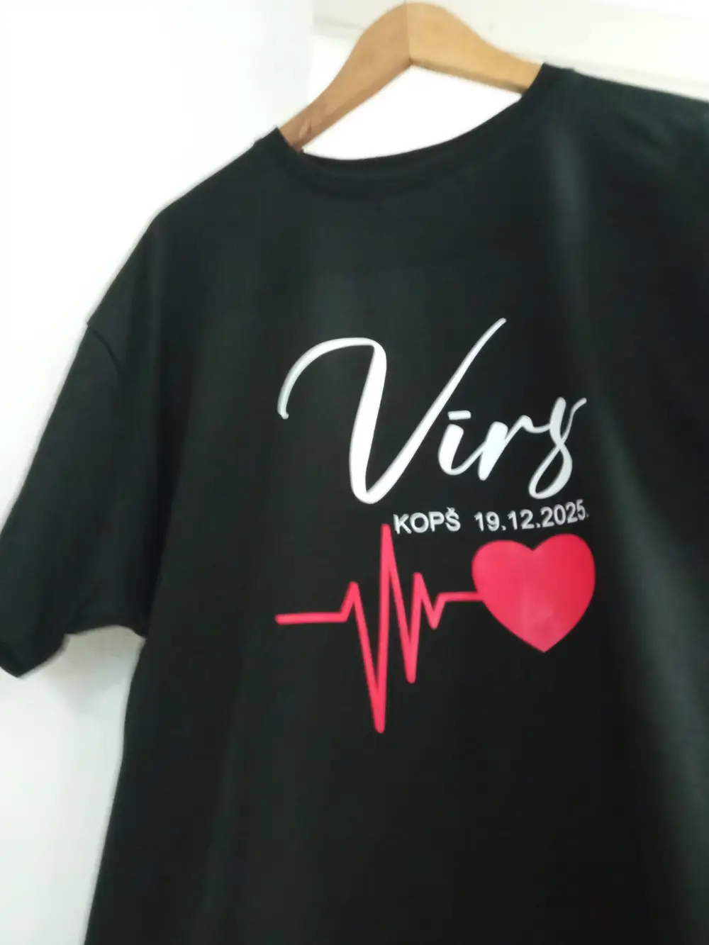 Black T-shirt reading "Vīrs kopš 19.12.2025" with a red heart